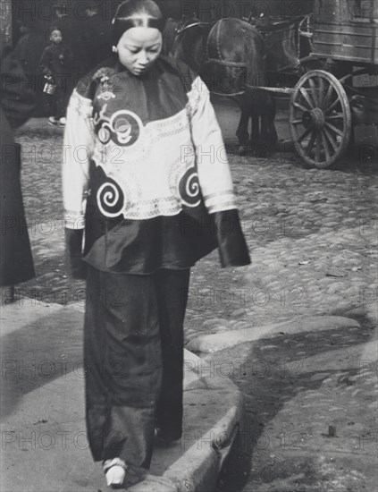 A woman in holiday attire, Chinatown, San Francisco, between 1896 and 1906. Creator: Arnold Genthe.