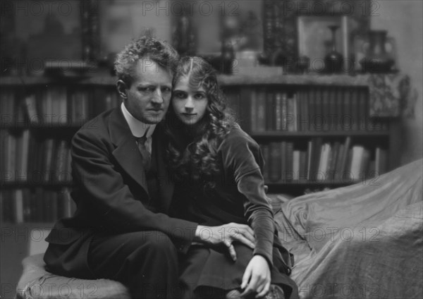 Arnold Genthe seated next to a woman friend in his studio in San Francisco, between 1896 and 1911. Creator: Arnold Genthe.