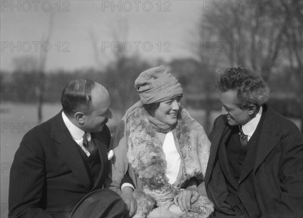 Arnold Genthe seated outdoors with two friends, between 1911 and 1942. Creator: Arnold Genthe.