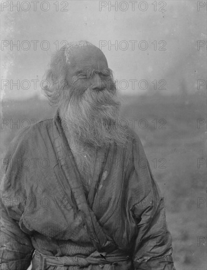 Ainu man standing outside, 1908. Creator: Arnold Genthe.