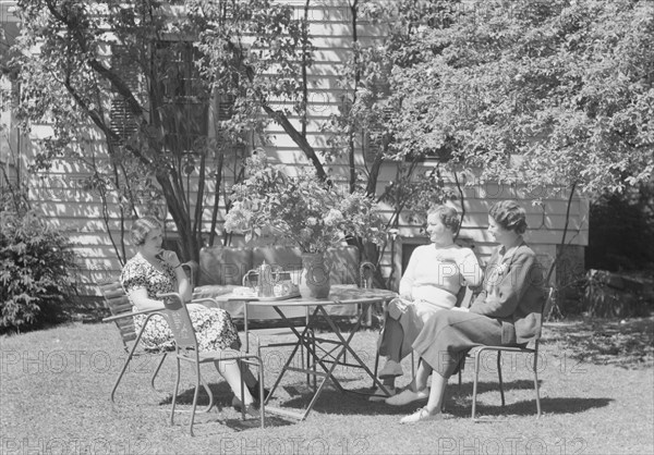 Mrs. Mary Benson and two identified women seated outdoors at a table, between 1933 and 1942. Creator: Arnold Genthe.