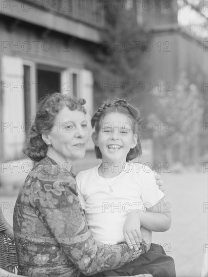 Mrs. Churchill with child Orrin, seated outdoors, not before 1932 Mar. Creator: Arnold Genthe.