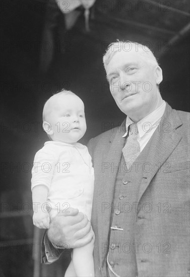 Captain Everett Edwards and baby, portrait photograph, 1933. Creator: Arnold Genthe.