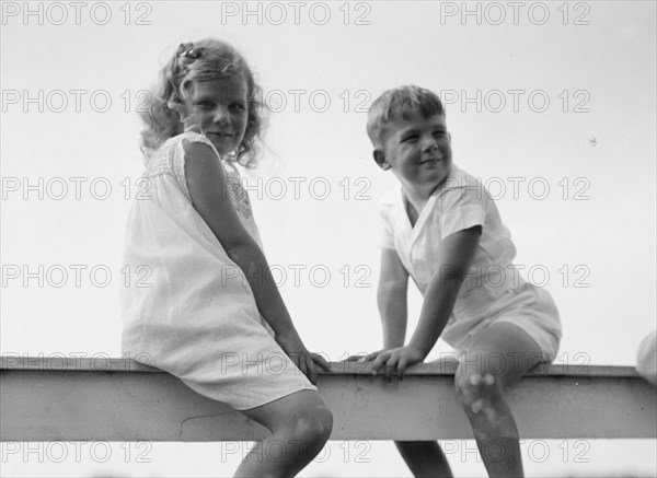 Kane children, seated on a fence, between 1911 and 1942. Creator: Arnold Genthe.