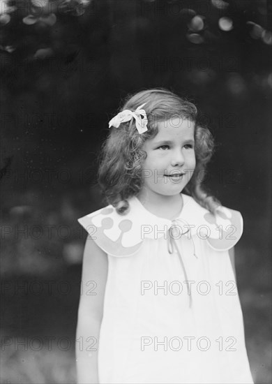 Daughter of W.G. Kimball, standing outdoors, between 1911 and 1942. Creator: Arnold Genthe.