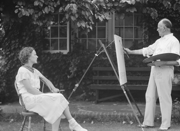 Mr. Hamilton King painting Mrs. Hamilton's portrait outdoors, between 1934 and 1942. Creator: Arnold Genthe.