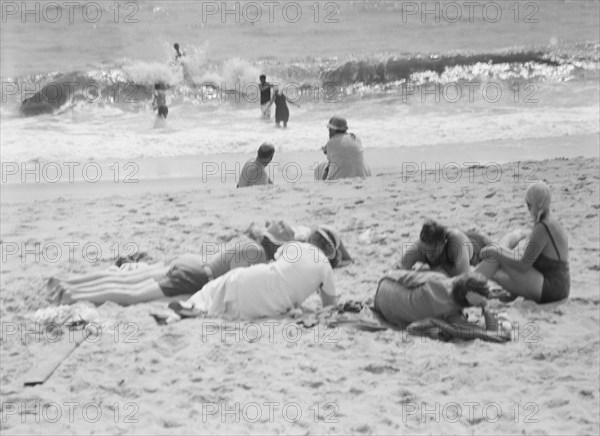 Unidentified group of people, possibly members of the Jewett family, at the beach, c1911-1942. Creator: Arnold Genthe.