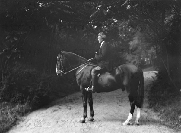 Arnold Genthe riding Chesty, between 1911 and 1936. Creator: Arnold Genthe.