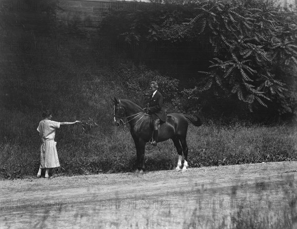 Arnold Genthe riding Chesty, between 1911 and 1936. Creator: Arnold Genthe.