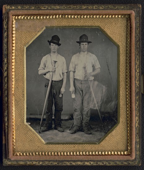 Occupational portrait of two men, standing full length holding floor rammers..., ca. 1850. Creator: Unknown.