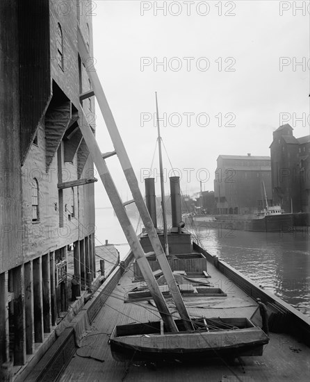 Unloading wheat into elevators, Buffalo, c1900. Creator: Unknown.