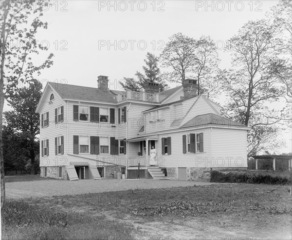 Calloway residence, back, showing porch with woman, Mamaroneck, N.Y., between 1900 and 1915. Creator: William H. Jackson.