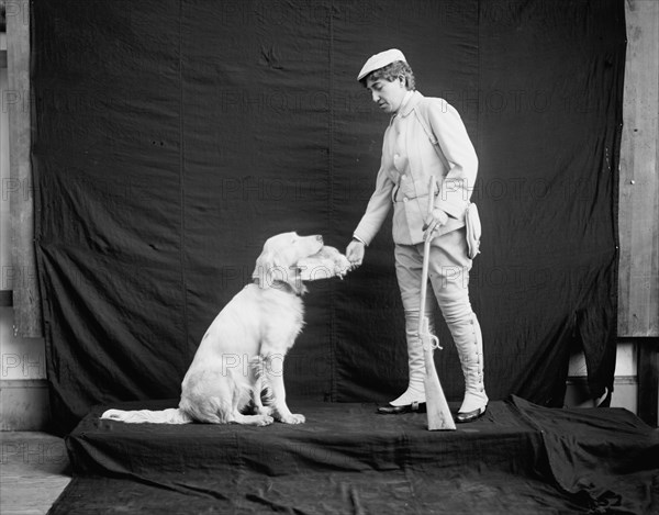 Billy and his mistress in hunting poses, between 1895 and 1910. Creator: Unknown.