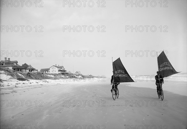 Sailing bicycles on the beach, Ormond, Fla., between 1900 and 1910. Creator: Unknown.