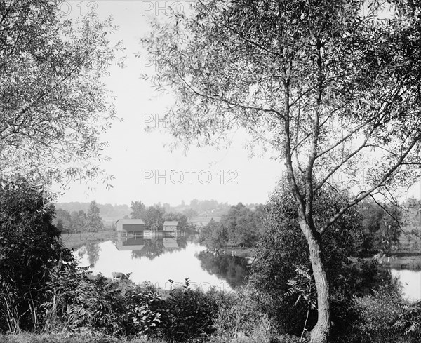 Buildings by river, probably the Huron River, Ypsilanti, Michigan, between 1900 and 1910. Creator: Unknown.