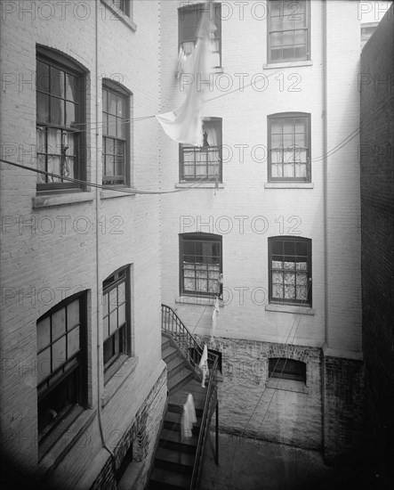 Court of tenement, New York City, between 1900 and 1910. Creator: Unknown.