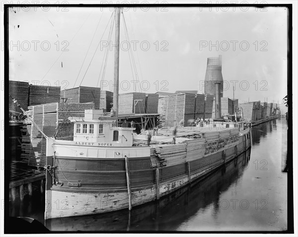 Loading lumber on steamer at lumberyards, Menominee, Mich., between 1880 and 1899. Creator: Unknown.