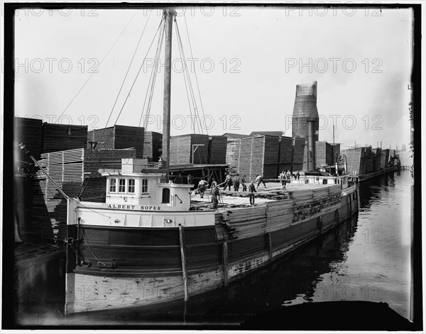 Loading lumber on steamer at lumberyards, Menominee, Mich., c1898. Creator: Unknown.