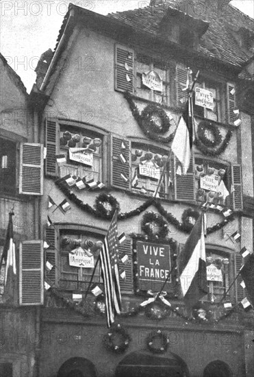 'Petain et Foch a Strasbourg; La parure de fete de Strasbourg liberee: deux facades ornees...,1918. Creator: Unknown.