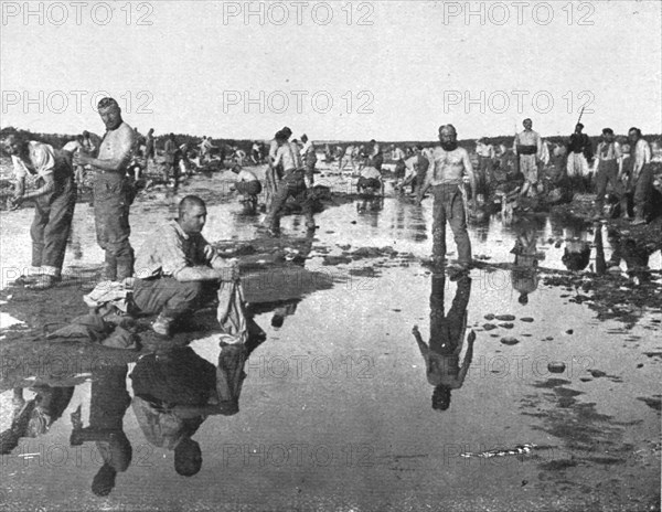 'Tandis que;..et d'autres se baignent sous un chaud soleil, dans l'oued Djedi, pres..., 1917. Creator: Unknown.
