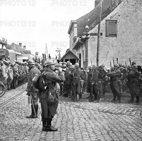 Operations in Flanders; Belgian troops pay honour to the flag of a French regiment..., 1917. Creator: Unknown.