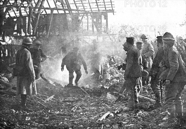 'Dans Cantigny; au milieu de la fumee des lance-flammes, les Allemands, un par un..., 1918. Creator: Unknown.