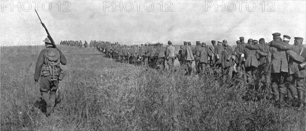 'A travers le champ de bataille; colonne de prisonniers allemands diriges sur l'arriere..., 1918. Creator: Unknown.