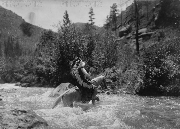 Bullchief at the ford, c1905. Creator: Edward Sheriff Curtis.