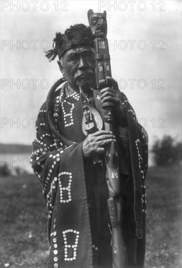 Hamasaka in Tluwulahu costume with speaker's staff-Qagyuhl [principal chief], c1914. Creator: Edward Sheriff Curtis.