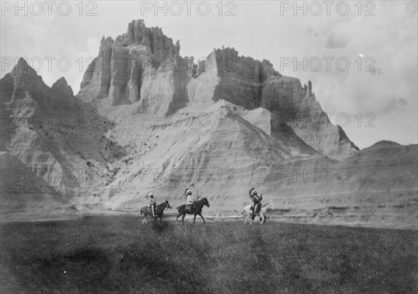 Entering the Bad Lands. Three Sioux Indians on horseback, c1905. Creator: Edward Sheriff Curtis.