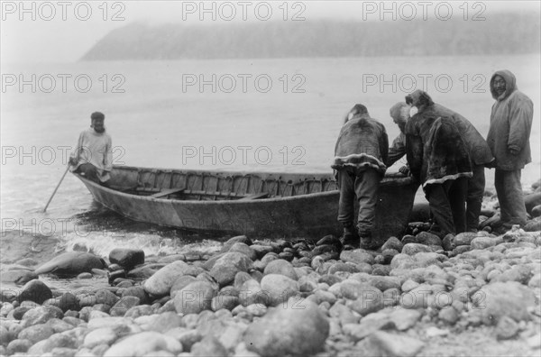 Launching the boat-Little Diomede Island, c1928. Creator: Edward Sheriff Curtis.