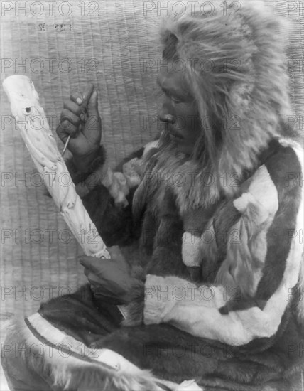 The ivory carver-Nunivak, c1929. Creator: Edward Sheriff Curtis.