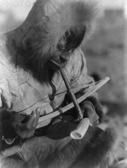 Drilling ivory-King Island, c1929. Creator: Edward Sheriff Curtis.