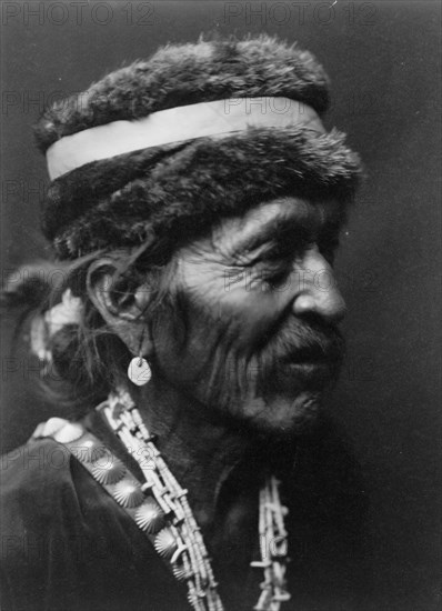 Navajo with fur cap, c1905. Creator: Edward Sheriff Curtis.