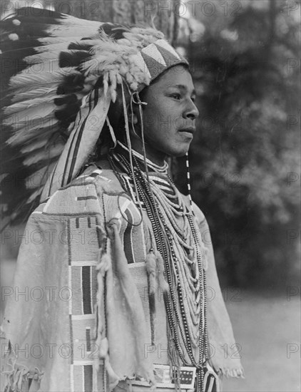 Youth in holiday costume-Umatilla, c1910. Creator: Edward Sheriff Curtis.