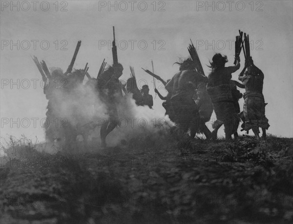 Dancing to restore an eclipsed moon, c1914. Creator: Edward Sheriff Curtis.