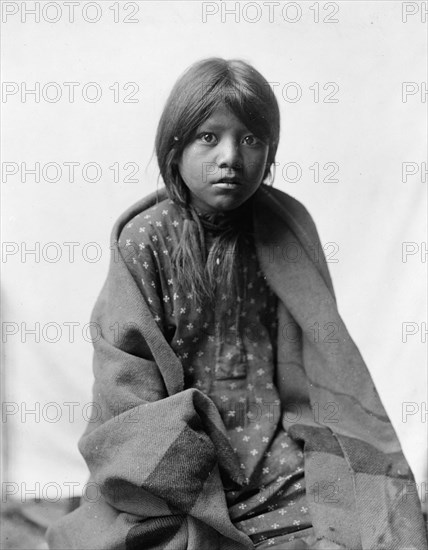 A Taos girl, three-quarter length portrait, seated, facing front, c1905. Creator: Edward Sheriff Curtis.