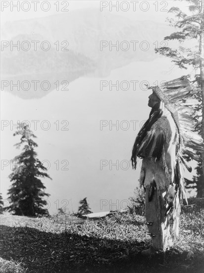 Praying to the Spirits at Crater Lake-Klamath, c1923. Creator: Edward Sheriff Curtis.