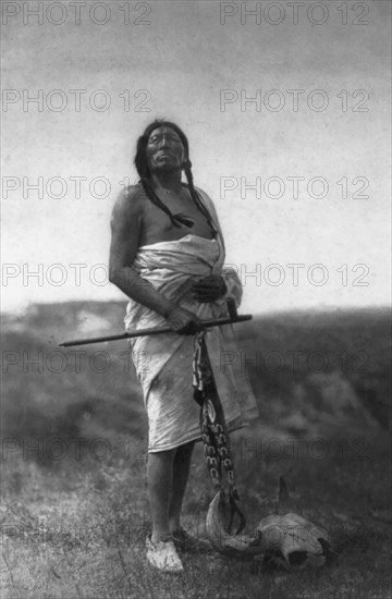 The Medicine Man (Slow Bull), c1907. Creator: Edward Sheriff Curtis.