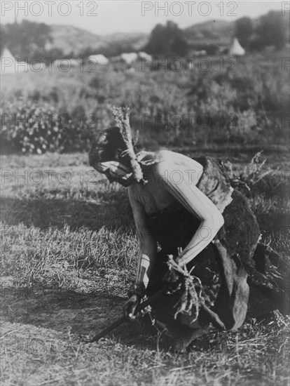 Offering the pipe to the Earth-Cheyenne, c1910. Creator: Edward Sheriff Curtis.