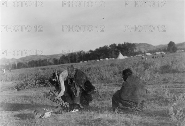 Offering pipe to the skull-Cheyenne, c1910. Creator: Edward Sheriff Curtis.