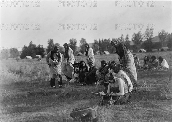 Priests passing before the pipe-Cheyenne, c1910. Creator: Edward Sheriff Curtis.