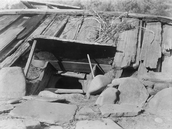 Entrance to a Yurok Sweat-house, c1923. Creator: Edward Sheriff Curtis.