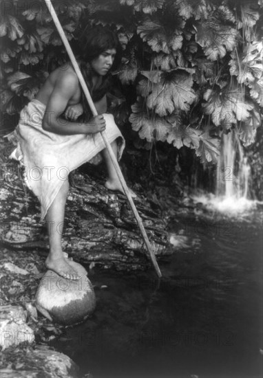 Spearing salmon, c1923. Creator: Edward Sheriff Curtis.