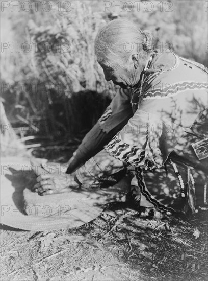 Grinding wokas-Klamath, c1923. Creator: Edward Sheriff Curtis.