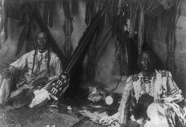 In a Piegan lodge, c1910. Creator: Edward Sheriff Curtis.