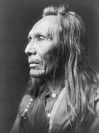 Three Eagles, a Nez Percé Indian, head-and-shoulders portrait, facing left, c1910. Creator: Edward Sheriff Curtis.