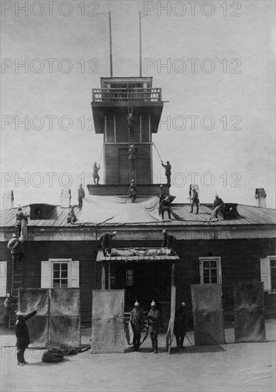 Irkutsk police fire brigade. Exercise with tarpaulins, shields, crowbar and hooks, 1894. Creator: R Prorokov.