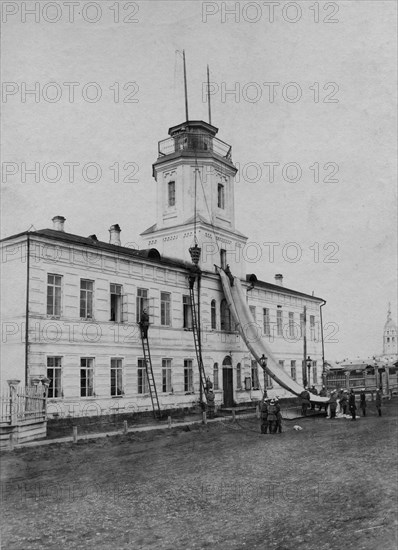 Irkutsk police fire brigade. Exercise with a rescue sheet and a rescue basket, 1894. Creator: R Prorokov.