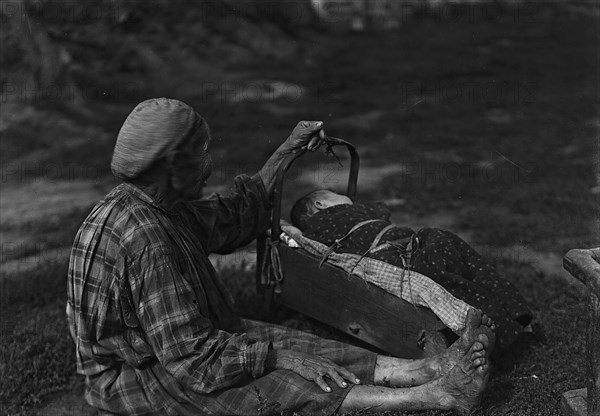 A woman with a cradle, 1890.  Creator: Unknown.